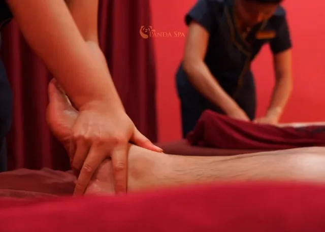 Photo of therapist performing foot acupressure for guest